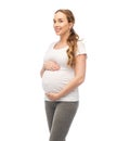 Happy pregnant woman touching her big belly Royalty Free Stock Photo