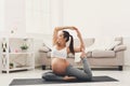 Happy pregnant woman training yoga in camel pose Royalty Free Stock Photo