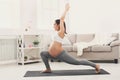 Happy pregnant woman training yoga in hero pose Royalty Free Stock Photo