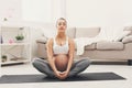 Happy pregnant woman training yoga in lotus pose Royalty Free Stock Photo