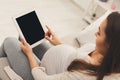 Happy pregnant woman using digital tablet at home Royalty Free Stock Photo