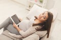 Happy pregnant woman using digital tablet at home Royalty Free Stock Photo