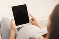 Happy pregnant woman using digital tablet at home Royalty Free Stock Photo