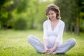 Happy pregnant woman working out in park. Copy space Royalty Free Stock Photo