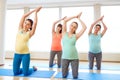 Happy pregnant women exercising on mats in gym Royalty Free Stock Photo