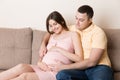 Happy pregnant woman and her husband waiting for baby at the home. happy family love and care concept Royalty Free Stock Photo