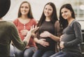 Happy pregnant women are talking together at antenatal class at the hospital