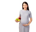 Happy pregnant young asian mother hold bowl glass contain fruit for eating. It is healthy food for fetus, baby and pregnant woman Royalty Free Stock Photo