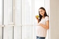 Happy pregnant young woman holding green apple Royalty Free Stock Photo