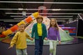 Happy preschool children having fun in play area standing in circle