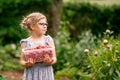 Happy preschool girl holding box with healthy strawberries from organic berry farm in summer, on sunny day. Smiling Royalty Free Stock Photo