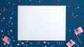 Happy Presidents Day background with blank paper card, confetti stars and American flags on blue. Flat lay, top view, copy space. Royalty Free Stock Photo