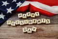 Happy Presidents Day Word alphabet letters with USA flag on wooden background Royalty Free Stock Photo