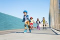 Boy playing roller skates with friends outdoors Royalty Free Stock Photo