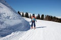 Happy preteen child, jumping with ski in a snow fun park. Kid skiing in Italy on a sunny day, kids and adults skiing together Royalty Free Stock Photo