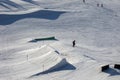 Happy preteen child, jumping with ski in a snow fun park. Kid skiing in Italy on a sunny day, kids and adults skiing together Royalty Free Stock Photo