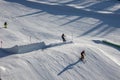 Happy preteen child, jumping with ski in a snow fun park. Kid skiing in Italy on a sunny day, kids and adults skiing together Royalty Free Stock Photo