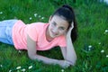 Happy preteen girl lying in the grass Royalty Free Stock Photo