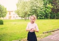 Happy preteen girl smiling on meadow in summer day at sunset