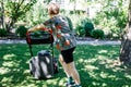 Happy preteen kid boy with lawn mower. Portrait of smiling teenager child working in garden, trimming grass. Garden Royalty Free Stock Photo