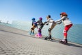 Happy preteen kids having fun while rollerblading