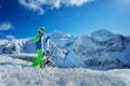 Happy preteen with ski standing over mountains Royalty Free Stock Photo