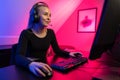 Happy Pretty Blonde Gamer Girl Playing Online Video Game on Her Personal Computer. Royalty Free Stock Photo