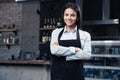 Happy pretty female waiter in apron