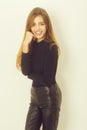 Happy pretty girl in black sweater and leather pants Royalty Free Stock Photo