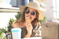 Happy pretty girl eating an ice cream while siting at summer street cafe Royalty Free Stock Photo