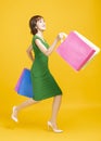 Happy pretty girl holding shopping bags and running Royalty Free Stock Photo