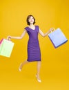 Happy pretty girl holding shopping bags and running Royalty Free Stock Photo