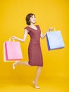 Happy pretty girl holding shopping bags and running Royalty Free Stock Photo