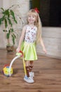 Happy pretty little blond girl cleaning house Royalty Free Stock Photo