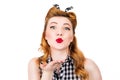Happy pretty pin up girl sending a kiss over white background Royalty Free Stock Photo