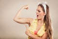 Happy pretty pin up girl showing off muscles. Royalty Free Stock Photo