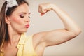 Happy pretty pin up girl showing off muscles. Royalty Free Stock Photo