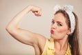 Happy pretty pin up girl showing off muscles. Royalty Free Stock Photo