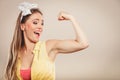 Happy pretty pin up girl showing off muscles. Royalty Free Stock Photo