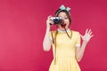 Happy pretty pinup girl taking pictures with vintage camera Royalty Free Stock Photo