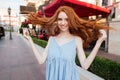 Happy pretty redhead girl with long hair posing