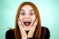 Happy pretty redhead girl looking laughing in camera in surprise