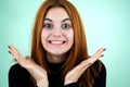 Happy pretty redhead girl looking laughing in camera in surprise
