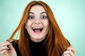 Happy pretty redhead girl looking laughing in camera in surprise