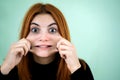 Happy pretty redhead girl looking laughing in camera in surprise