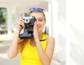 Happy pretty smiling young woman with retro vintage camera Royalty Free Stock Photo