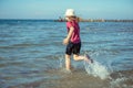 Happy pretty teen girl in neoprene swimingsuit  running in Baltic sea Royalty Free Stock Photo