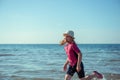 Happy pretty teen girl in neoprene swimingsuit  running in Baltic sea Royalty Free Stock Photo