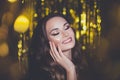 Happy pretty woman celebrity with makeup on golden glitter sparkle bokeh background