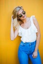 Happy pretty woman in the city, beautiful young girl posing against colorful wall Royalty Free Stock Photo